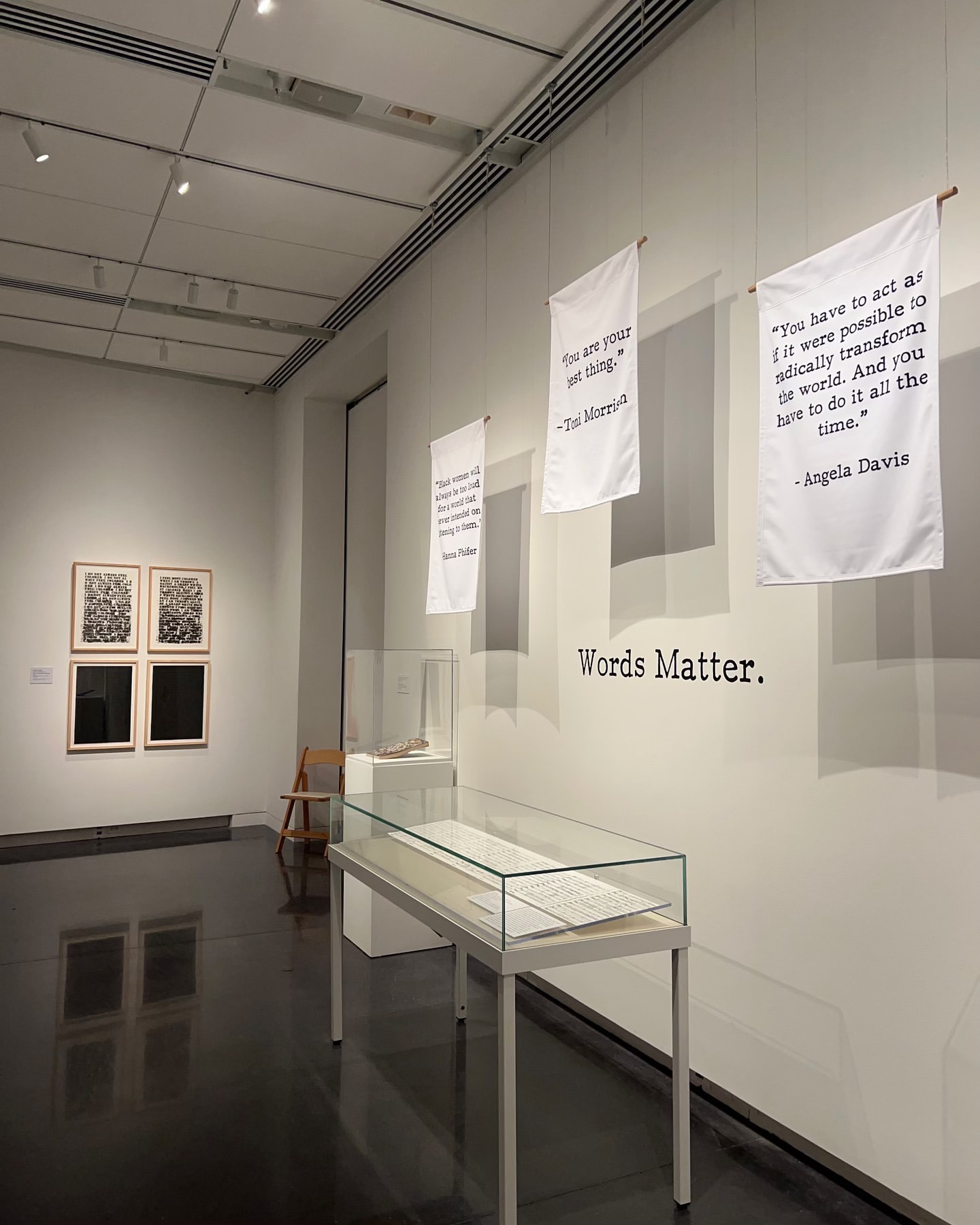 Words Matter — quote banners by Toni Morrison, Angela Davis & Hanna Phifer hang above the gallery's archive cases.