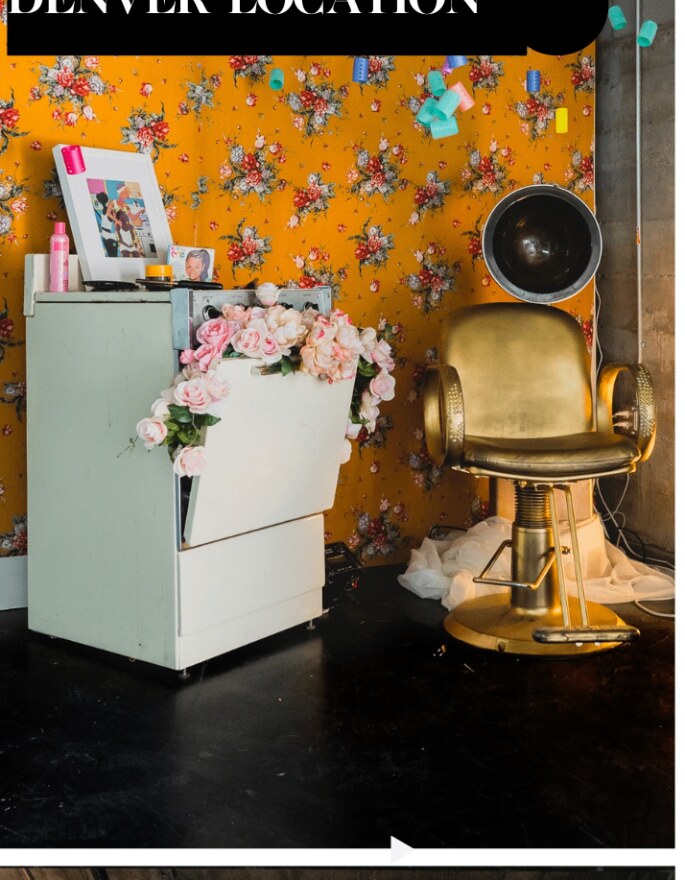 The iconic golden salon chair under floral wallpaper