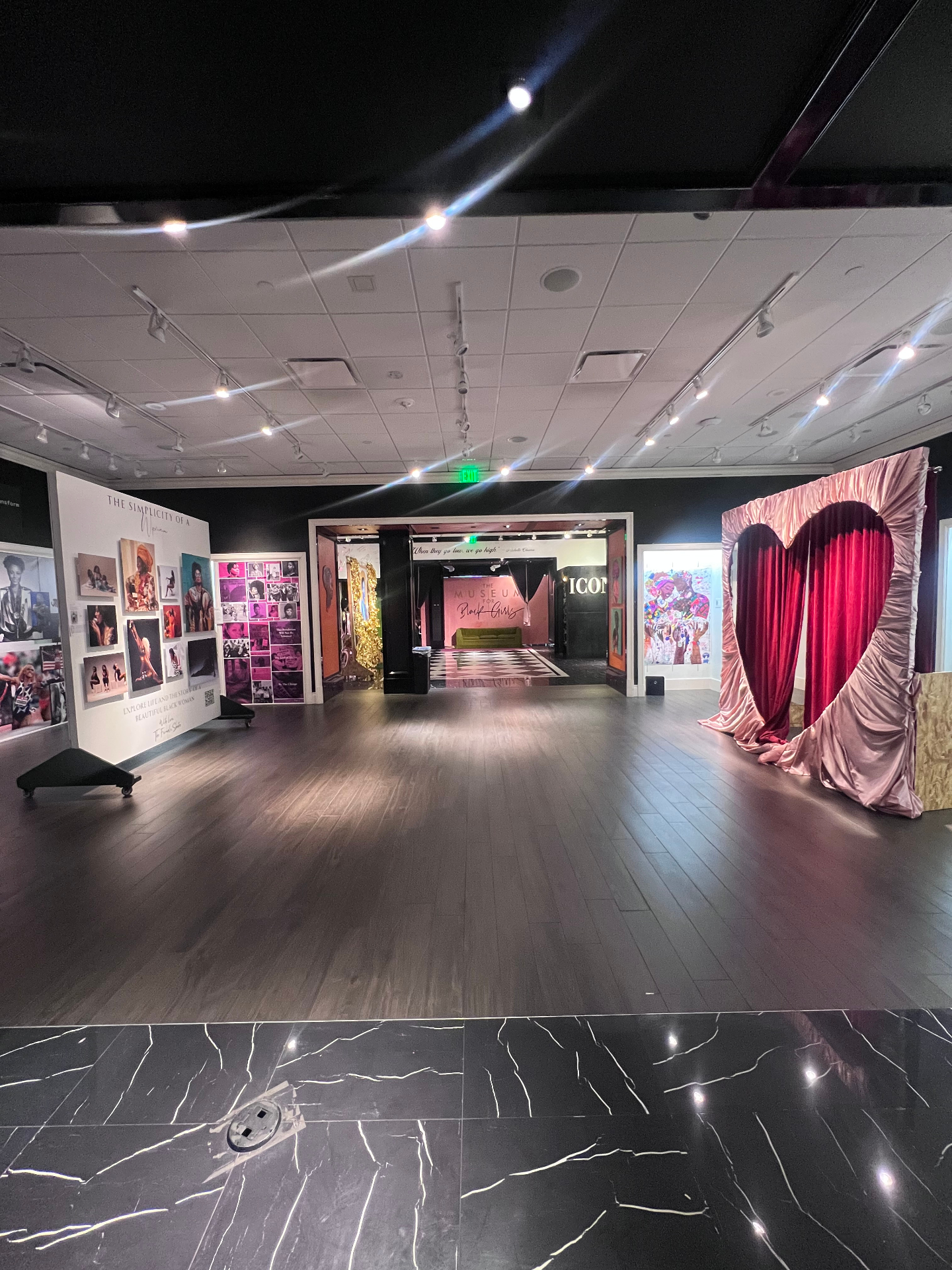 Wide cinematic view of the museum showing the heart curtain installation, ICON gallery and pink lounge in the distance
