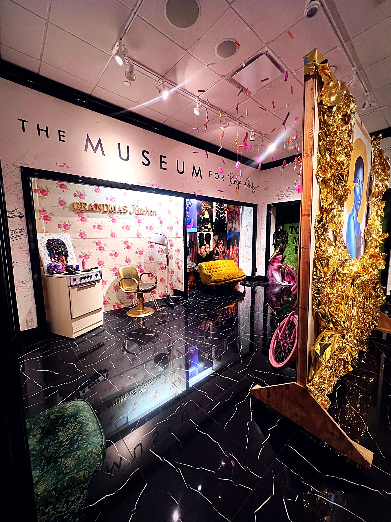 Grandma's Kitchen installation at Museum for Black Girls with gold leaf, pink florals and vintage salon chairs