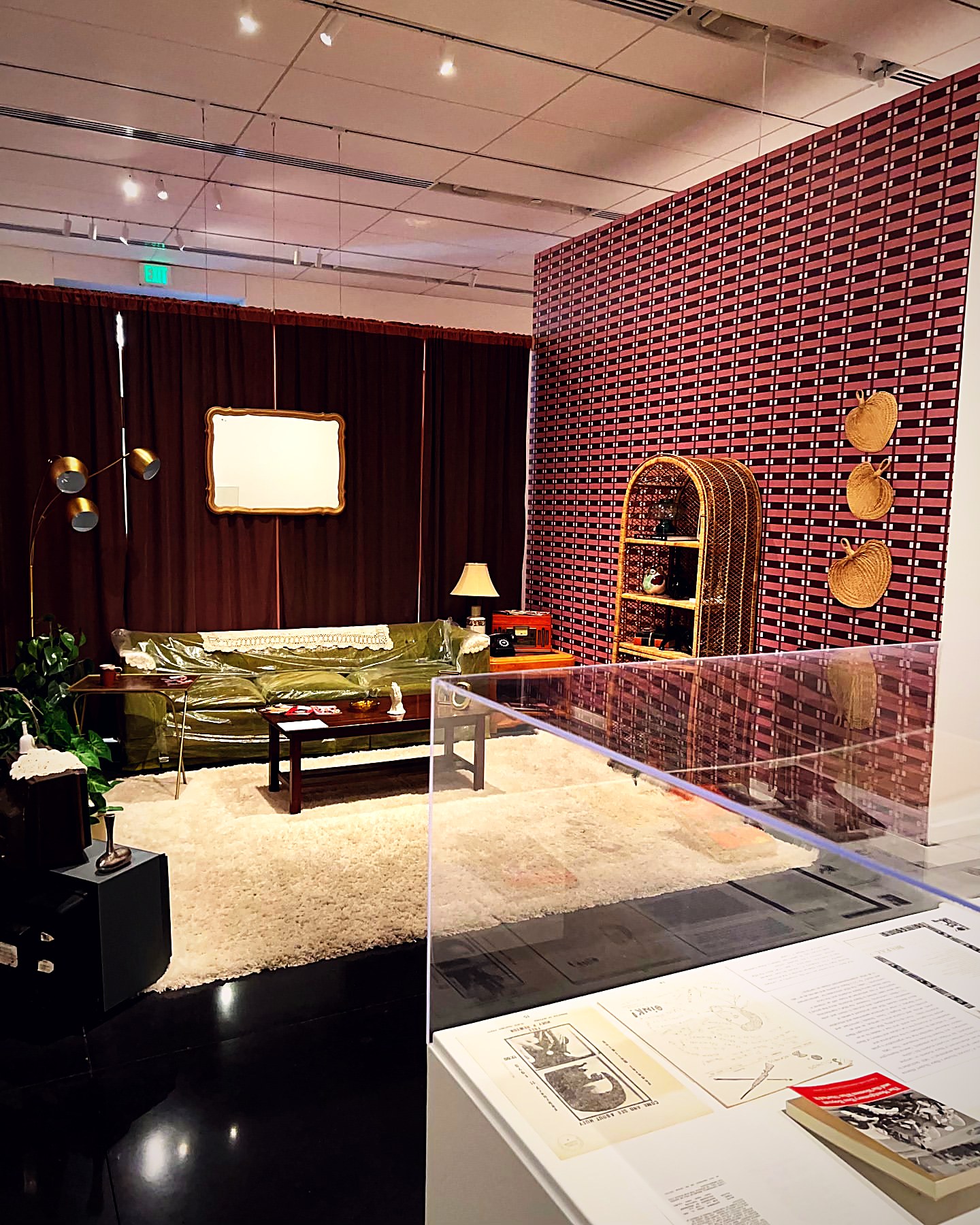 Green velvet lounge installation with layered seating at Museum for Black Girls
